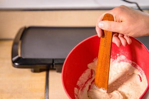 brown wood baking spatula stirring pancake batter - Earlywood