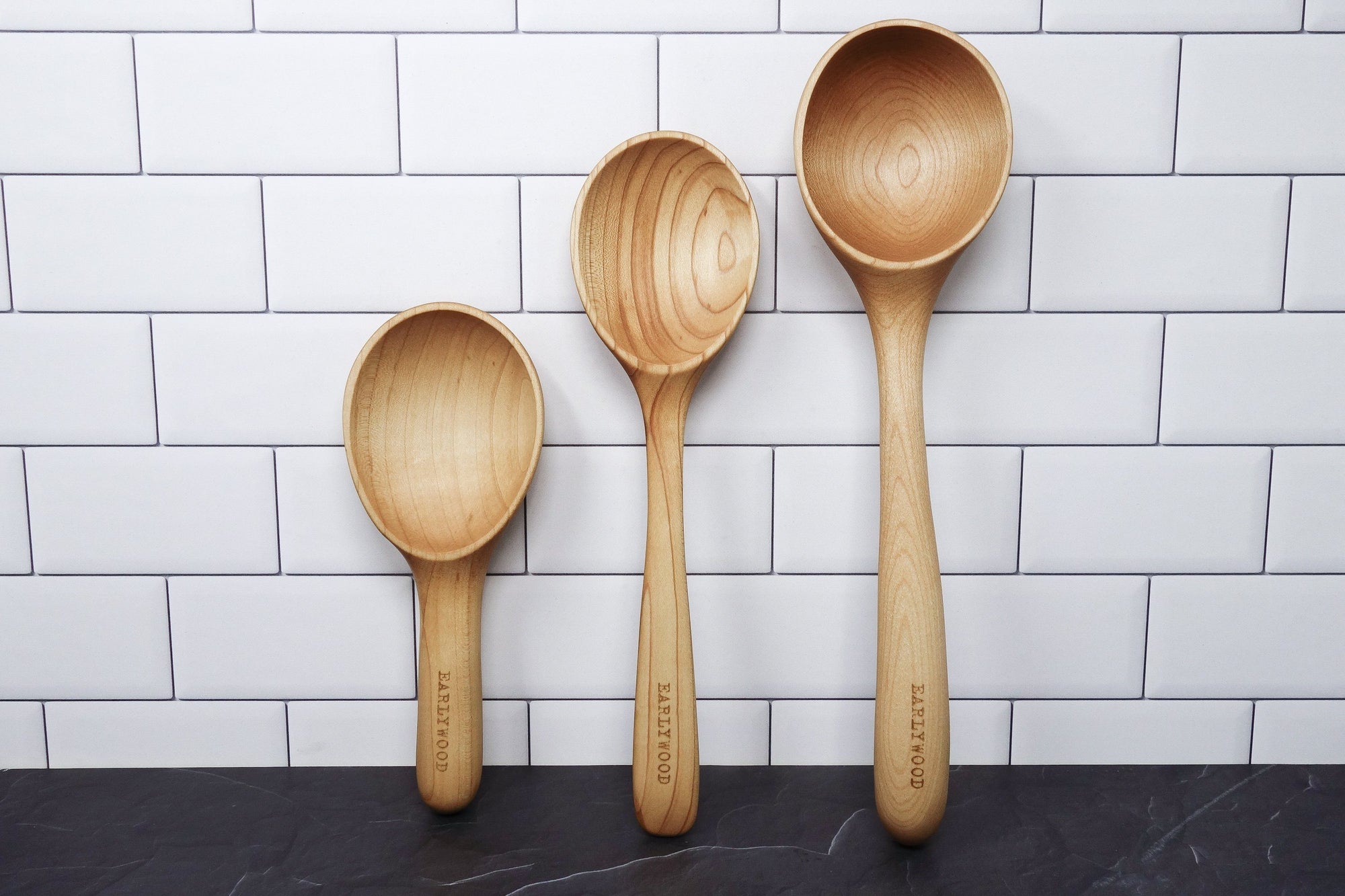 3 piece set of hard maple serving spoons leaning up against wall - Earlywood