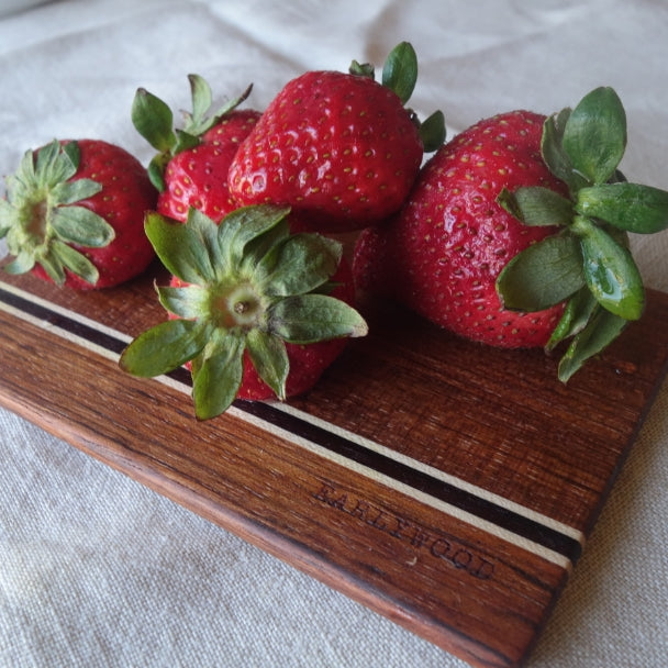 Fresh strawberries on wood cutting board