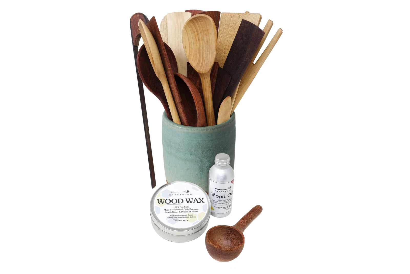 Set of wooden utensils in a container with wood care products on a white background