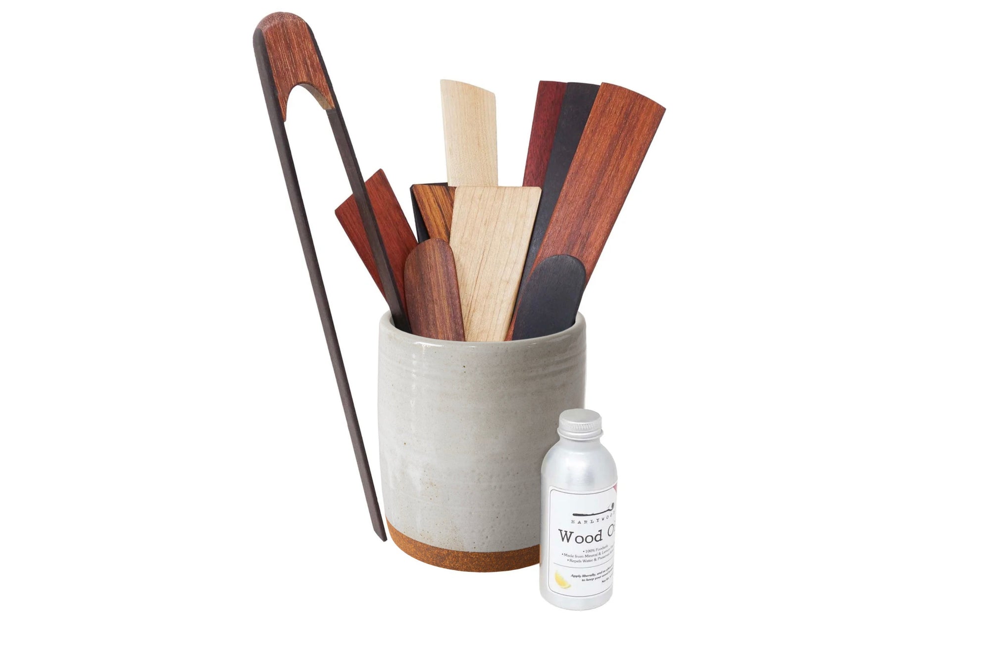 Set of wooden utensils in a container with a bottle labeled 'Wood Care' on a white background