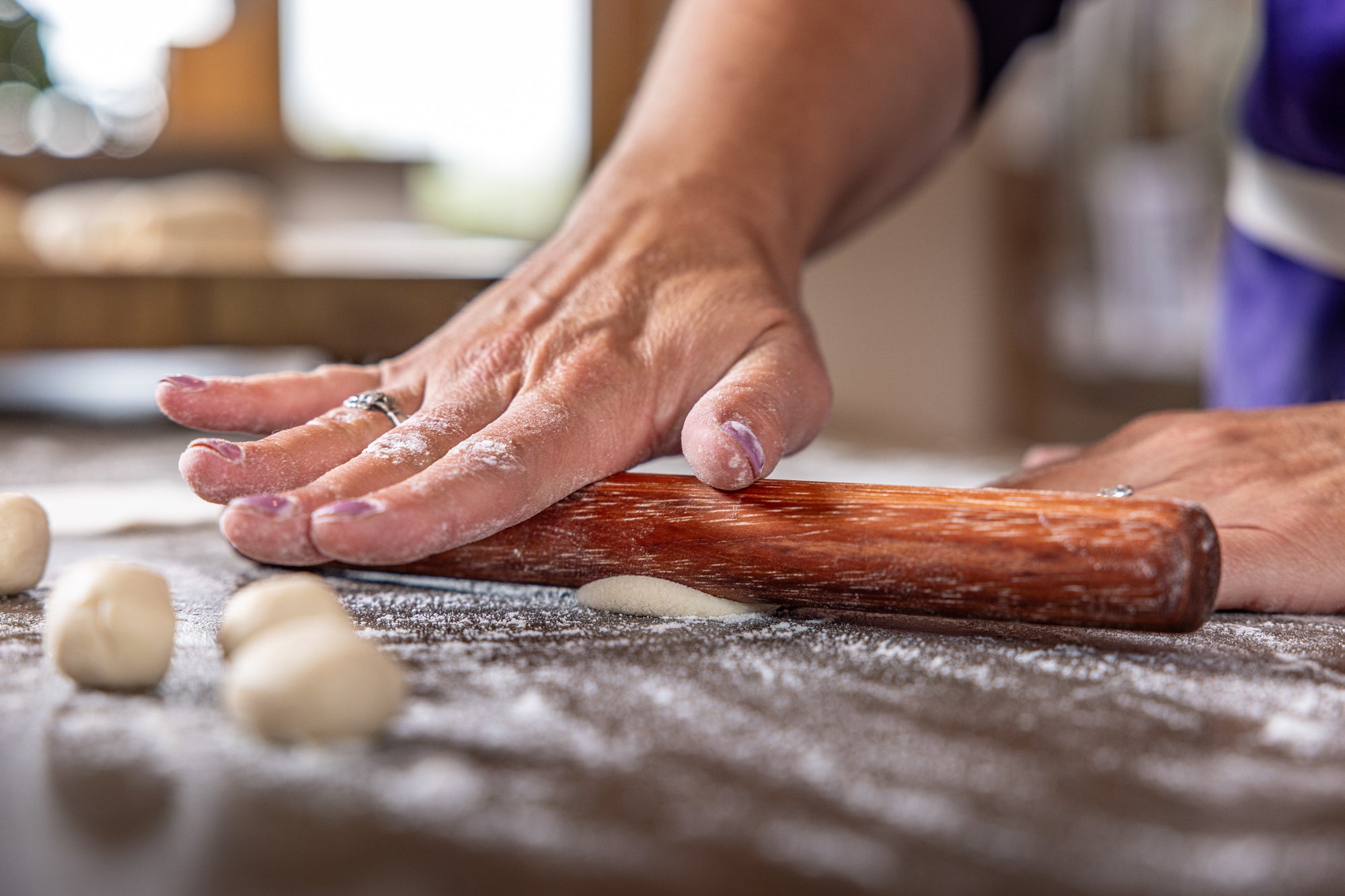 mini rolling dowel rolling out dough with one hand