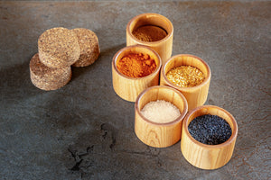 five salt cups with colorful spices 