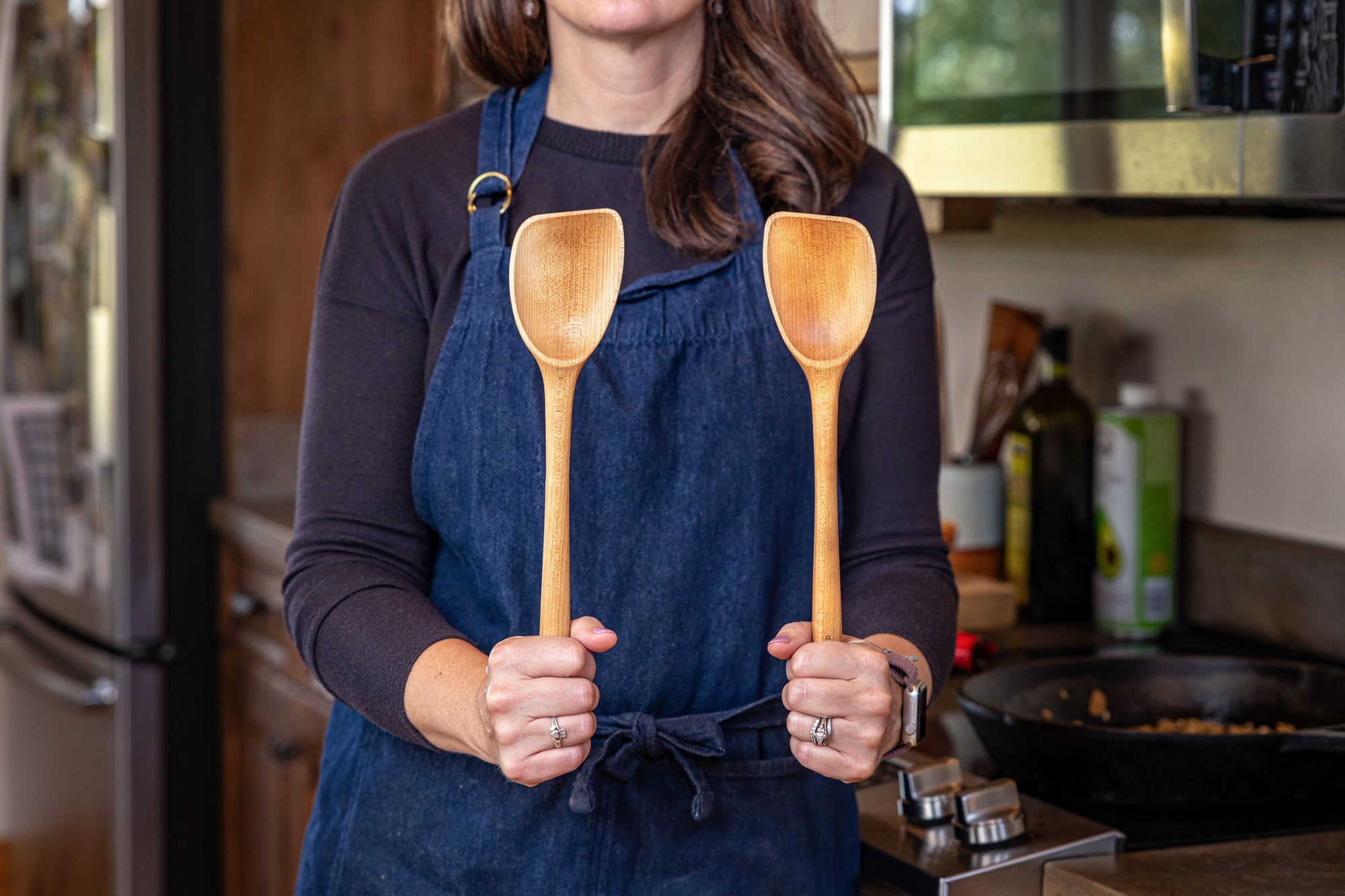 woman holding scraper spoon left and right 