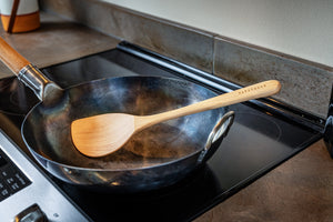 wok spatula in a wok on a stove top