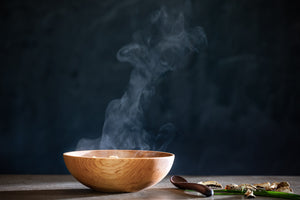 wooden soup bowl on counter with steam