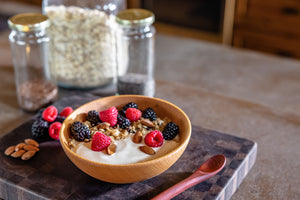 wooden breakfast bowl with yogurt and berries