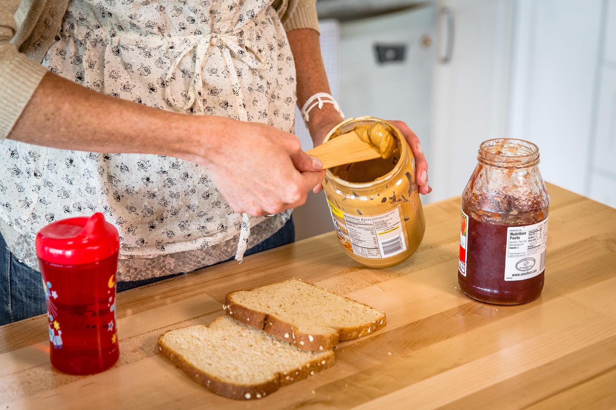 the best wooden spreader scooping peanut butter - Earlywood