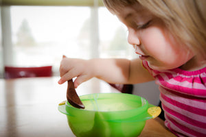 wooden feeding spoon in use by toddler - Earlywood