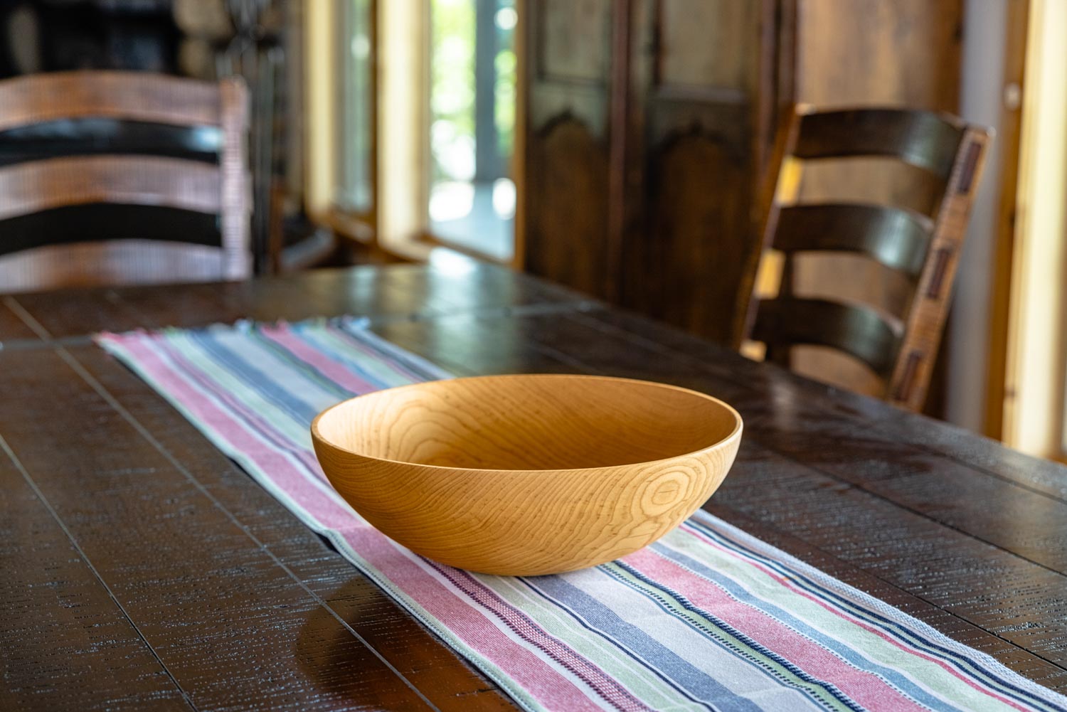 big wooden storage bowl on table in house