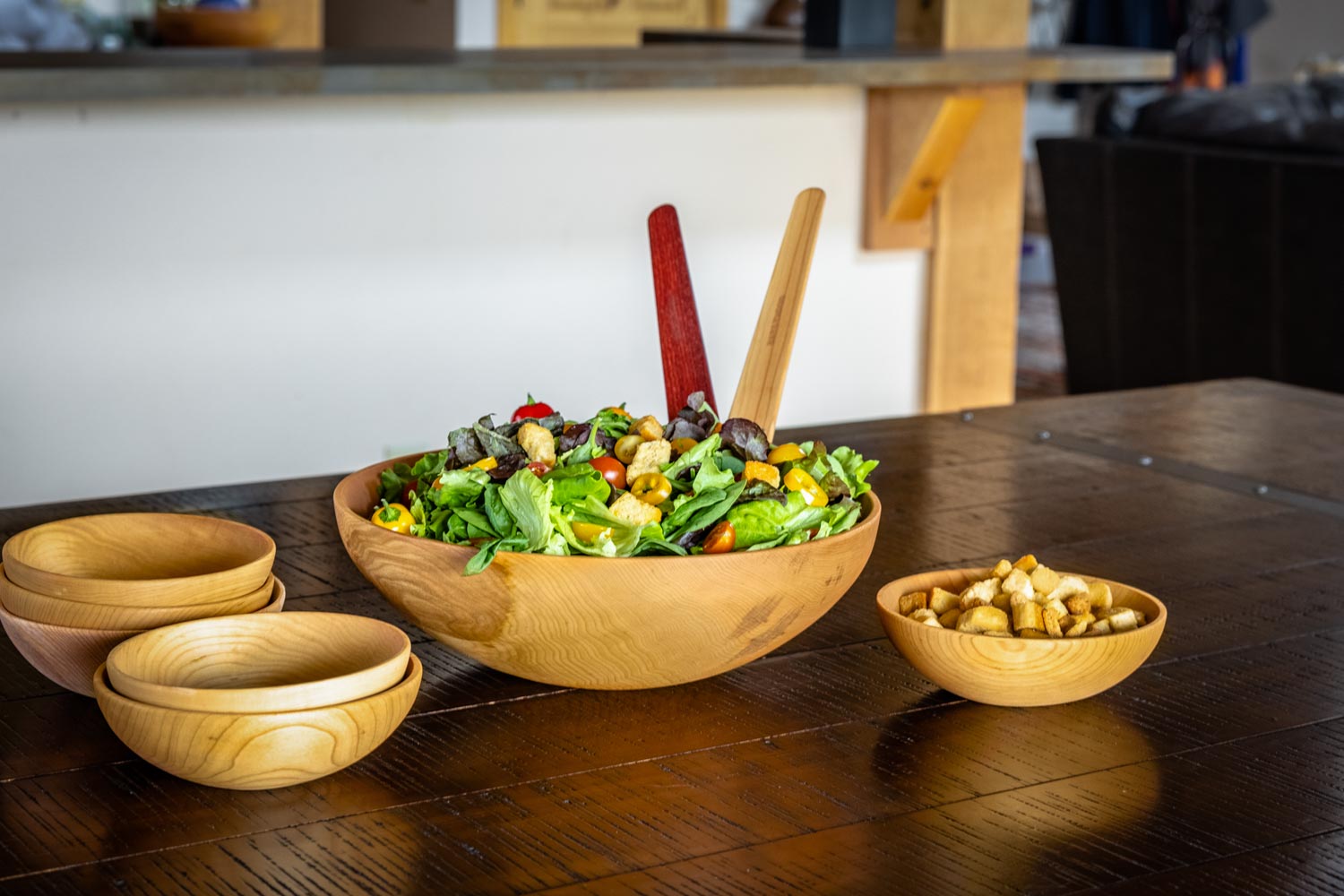 wooden salad bowl with serving bowls