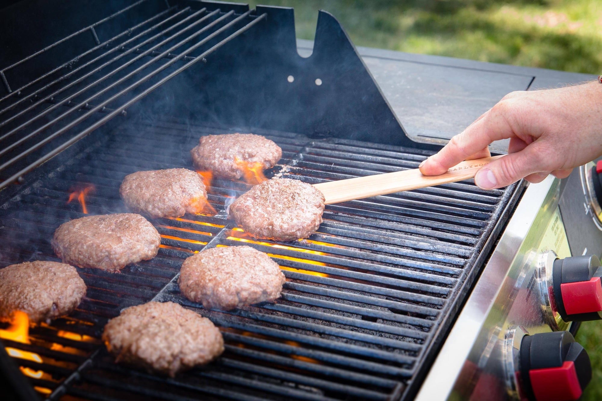 flipping burgers on grill with thin wood flipper -hard maple - Earlywood
