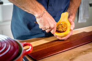 wood cheese knife scooping seeds out of squash - Earlywood