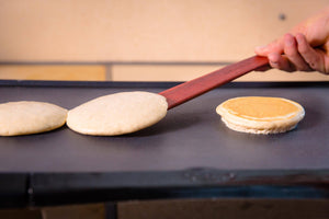 flipping pancakes with thin wood utensils for nonstick cookware - Earlywood