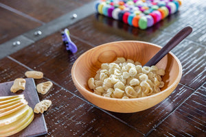 small wooden bowl with wooden baby spoon