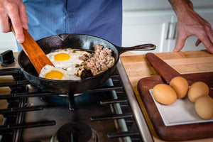 wooden cast iron scraper cooking eggs